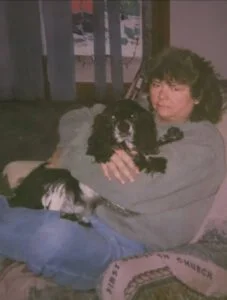 Leigh's mother holding her beloved dog, the inspiration behind The Scoop Ninjas' compassionate mission to support pet owners with chronic illness in Northeast Ohio.
