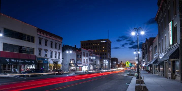 Scenic nighttime view of downtown Massillon, Ohio with local shops, restaurants, and light trails from passing cars—highlighting the city's vibrant small business community